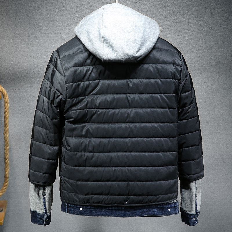 Black puffer jacket with white hood on a gray background