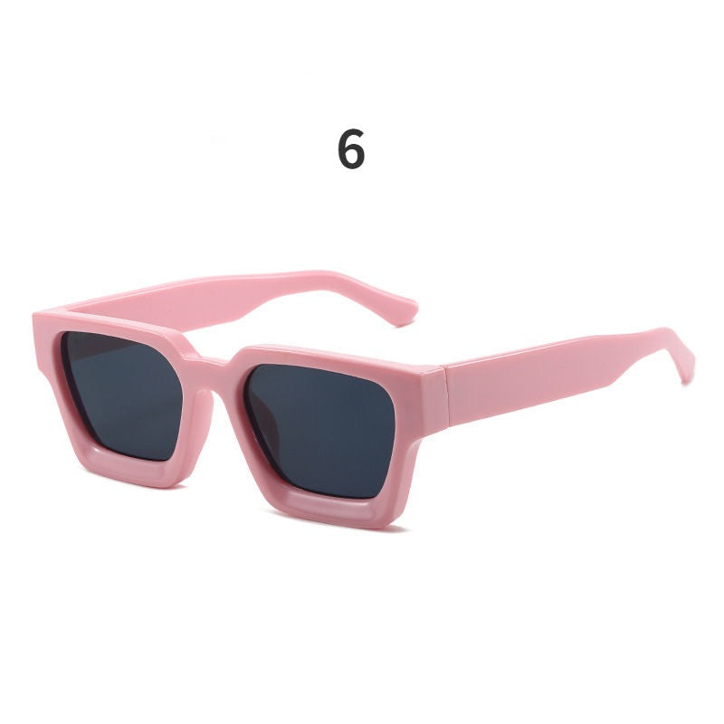 Pink sunglasses with dark lenses on a white background