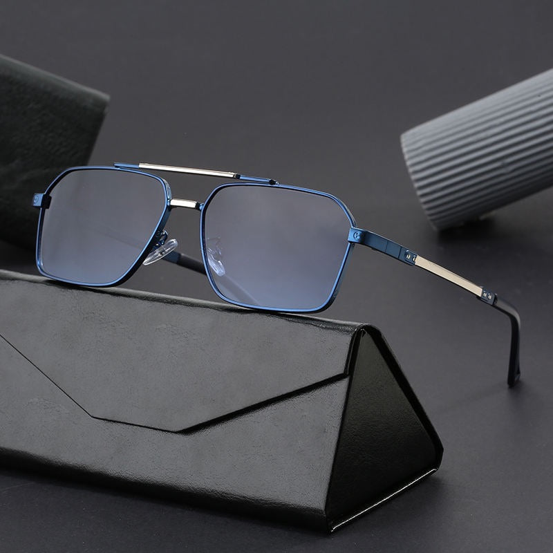 Blue square-framed glasses on a dark surface with a black stand and gray case.