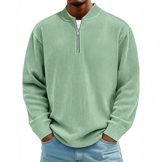 Green ribbed sweater worn by a person on a white background