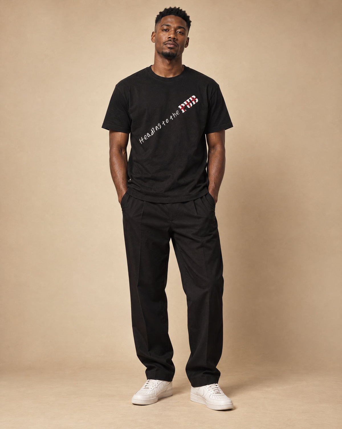 Kwame wearing SHOPHOODIE® HEADING TO THE PUB BRITISH ENGLAND Pure Cotton Unisex T-Shirt — 180 GSM