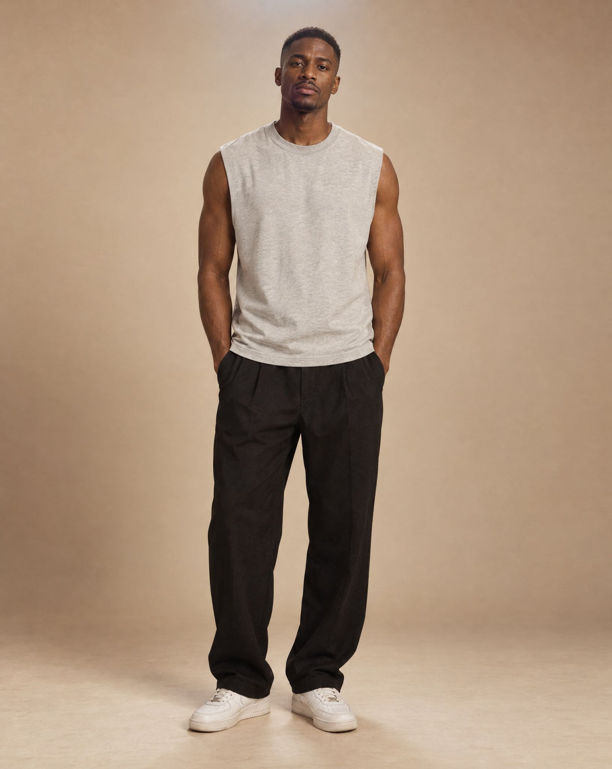 Male model wearing SHOPHOODIE BLANK Raw Edge Cotton Tank Top, studio shot