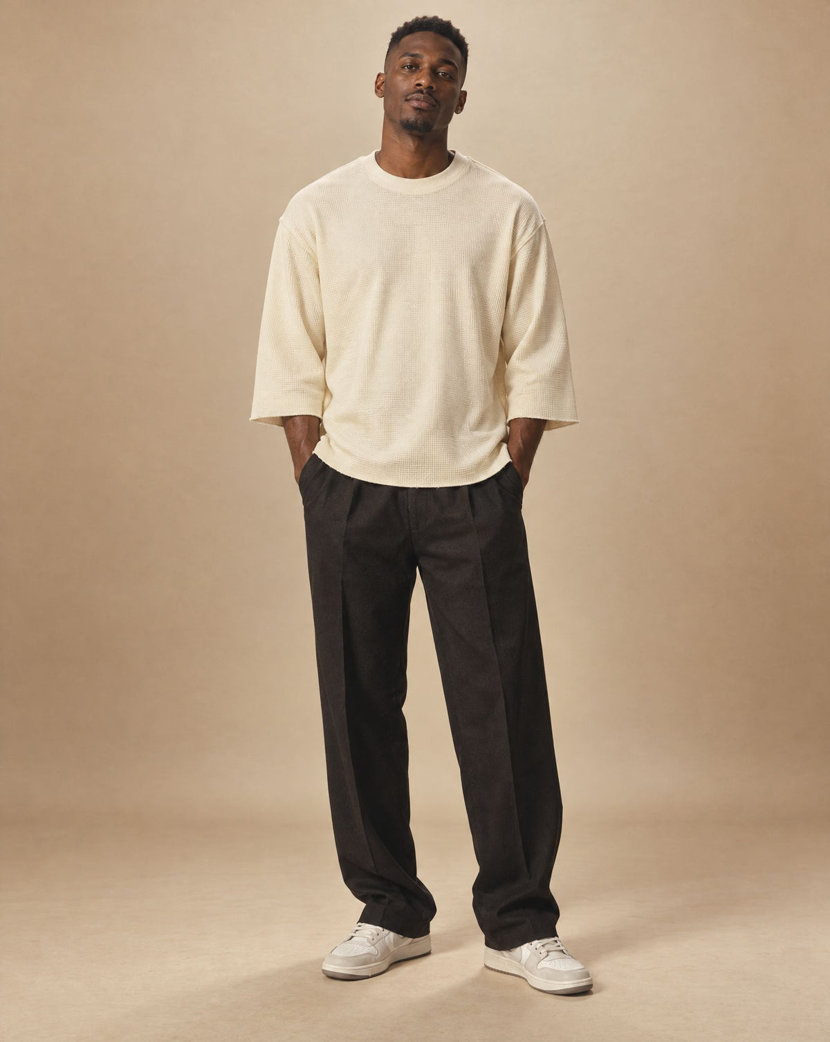 Kwame wearing SHOPHOODIE® BLANK Unisex Waffle Raw-Edge T-Shirt — 220 GSM