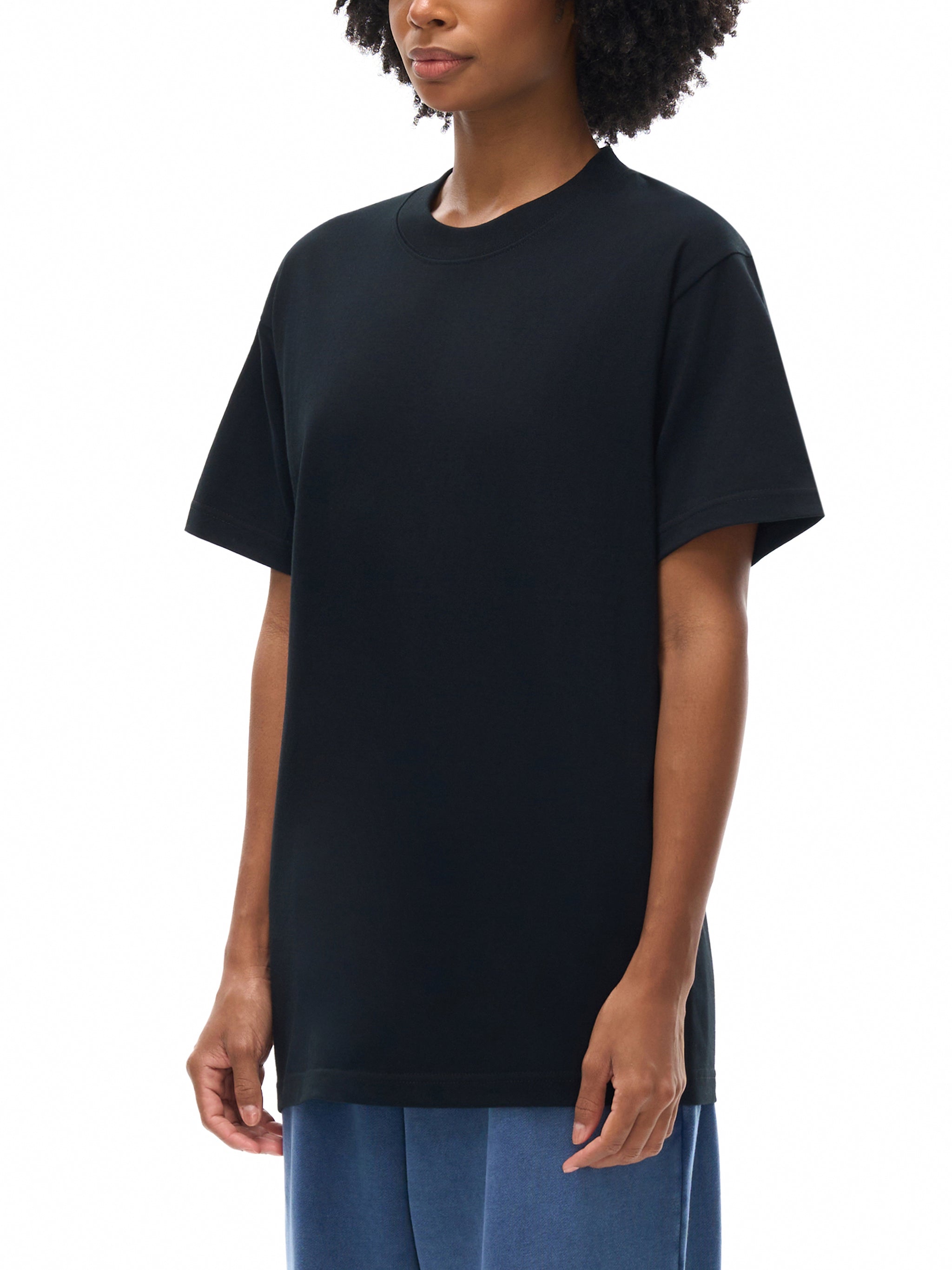 Person wearing a black t-shirt on a white background