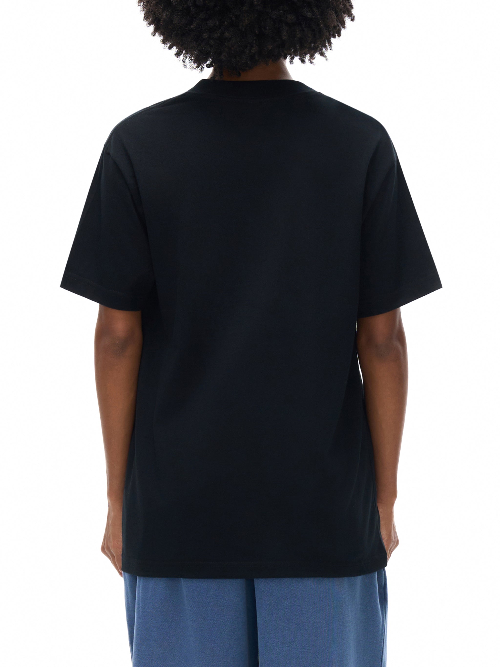 Person wearing a black t-shirt on a white background