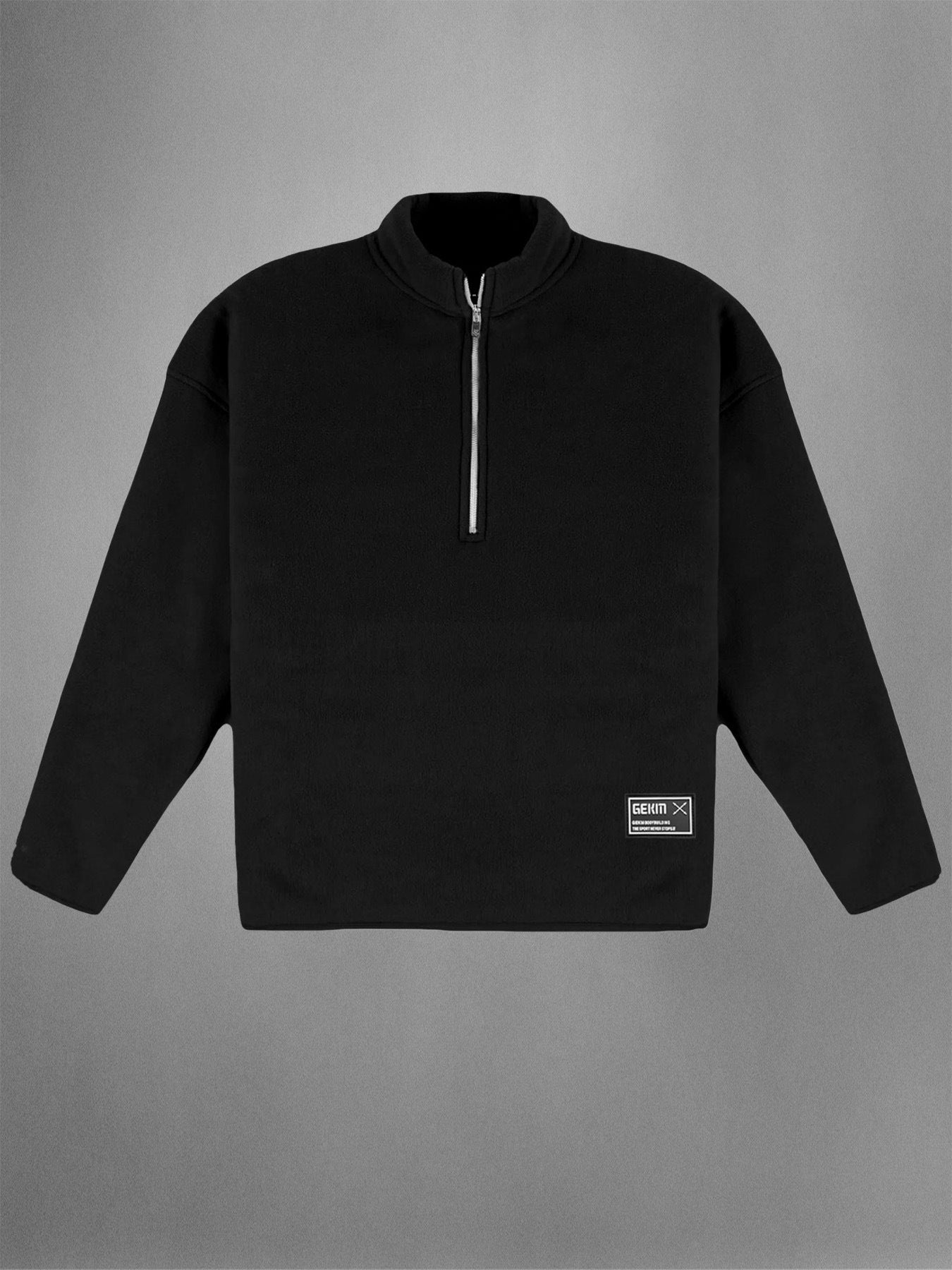 Black pullover with a quarter zip on a gray background