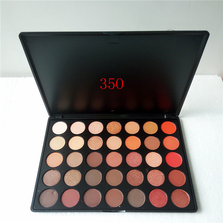 Makeup palette with various shades of eyeshadows on a white background
