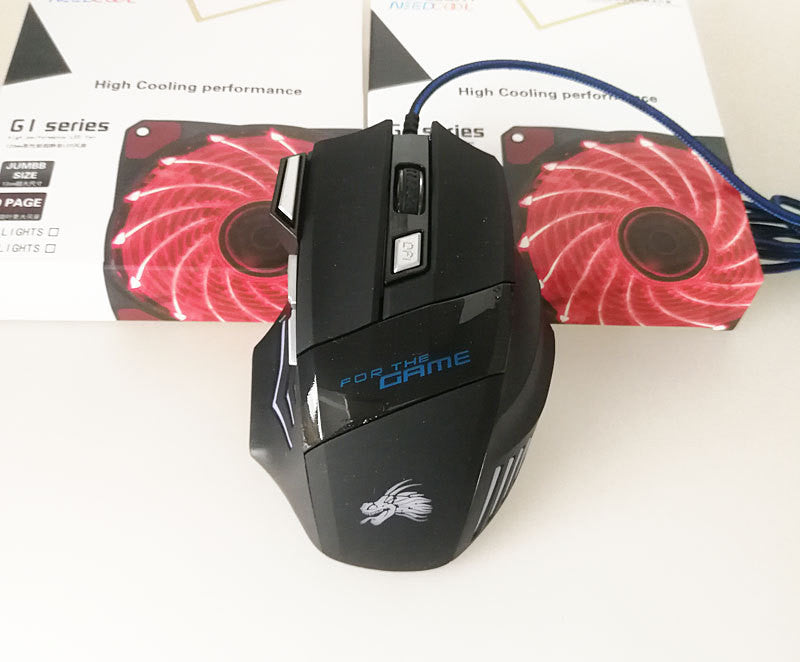 Black gaming mouse with 'For the Game' branding on a white surface with cooling fans in the background.