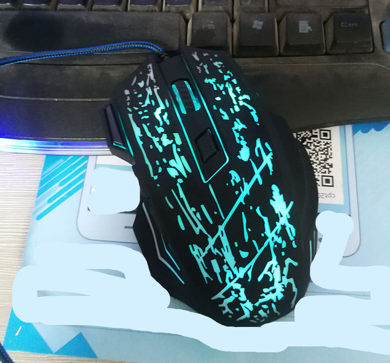 Glowing blue gaming mouse on a desk with keyboard and mouse pad
