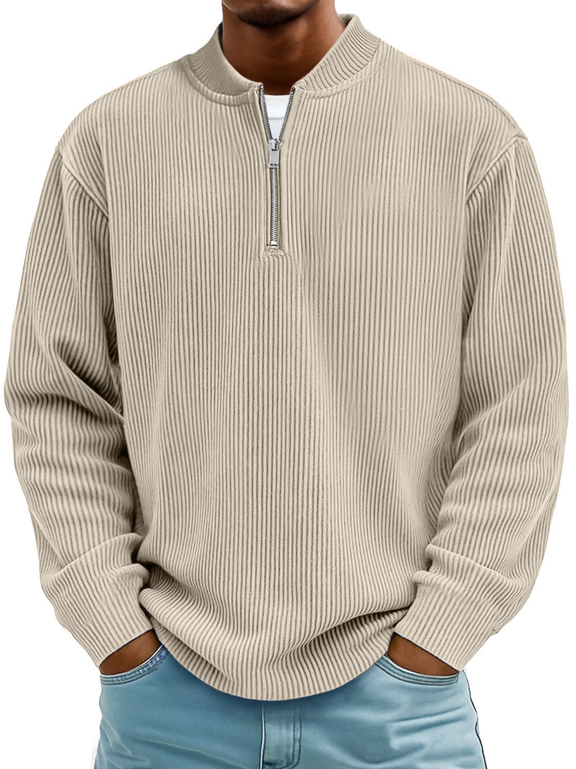 Man wearing a beige ribbed sweater with a quarter zip on a white background