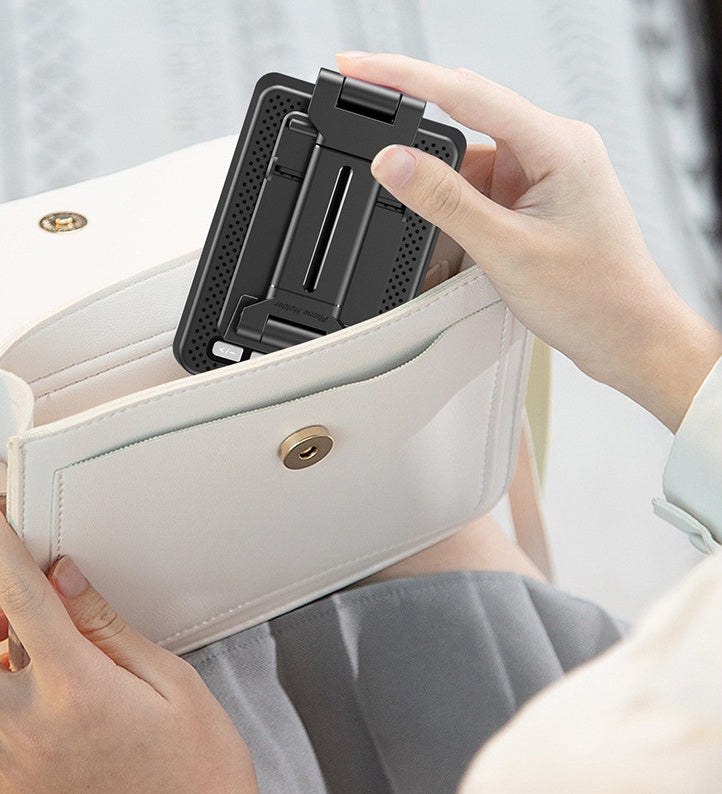 Person placing a black phone stand into a white wallet