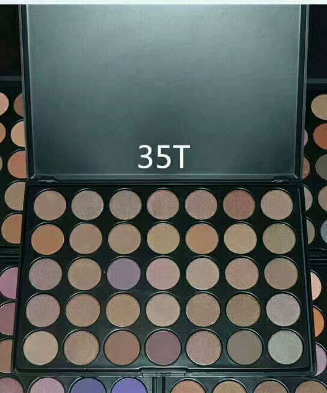 Makeup palette with 35 shades of eyeshadows on a black background
