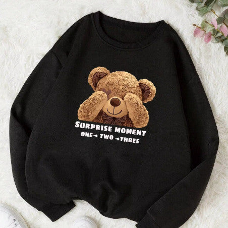 Black sweatshirt with a teddy bear graphic and text on a white surface
