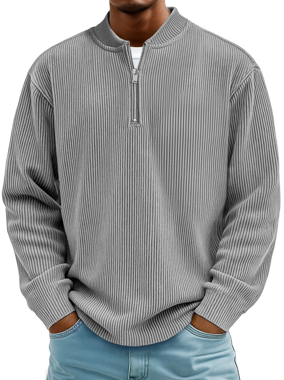 Person wearing a gray ribbed sweater with a quarter zip on a white background