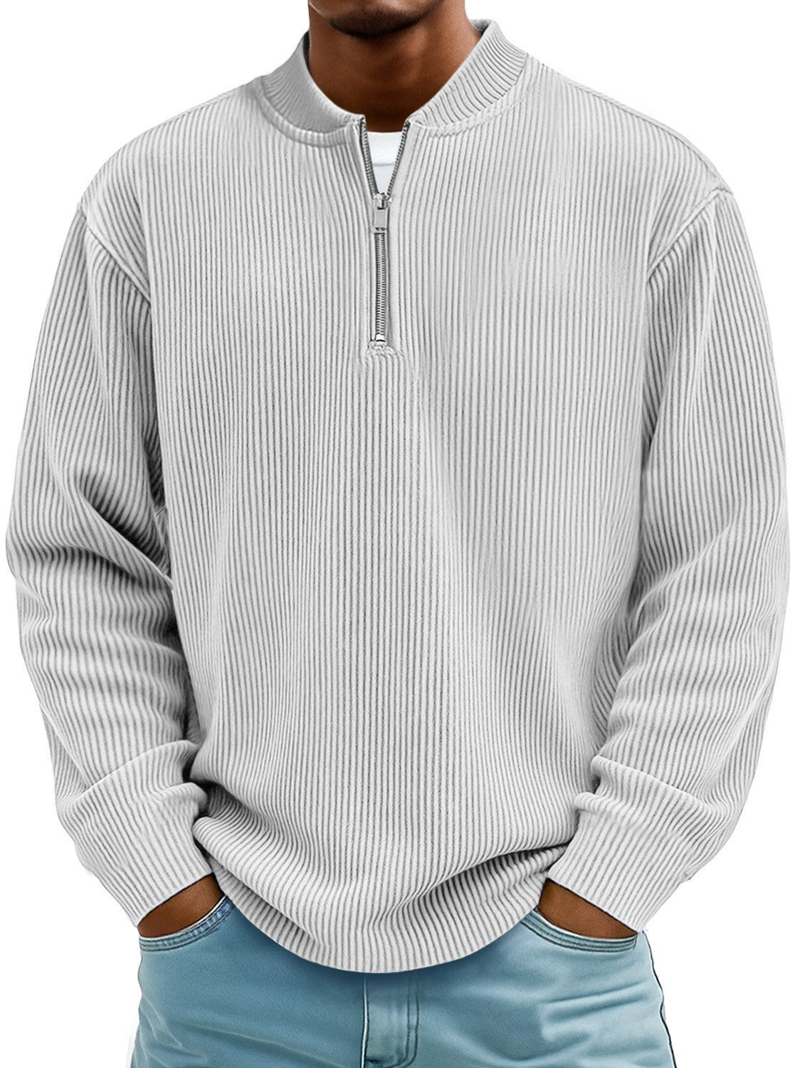 Man wearing a light gray ribbed sweater with a quarter zip on a white background