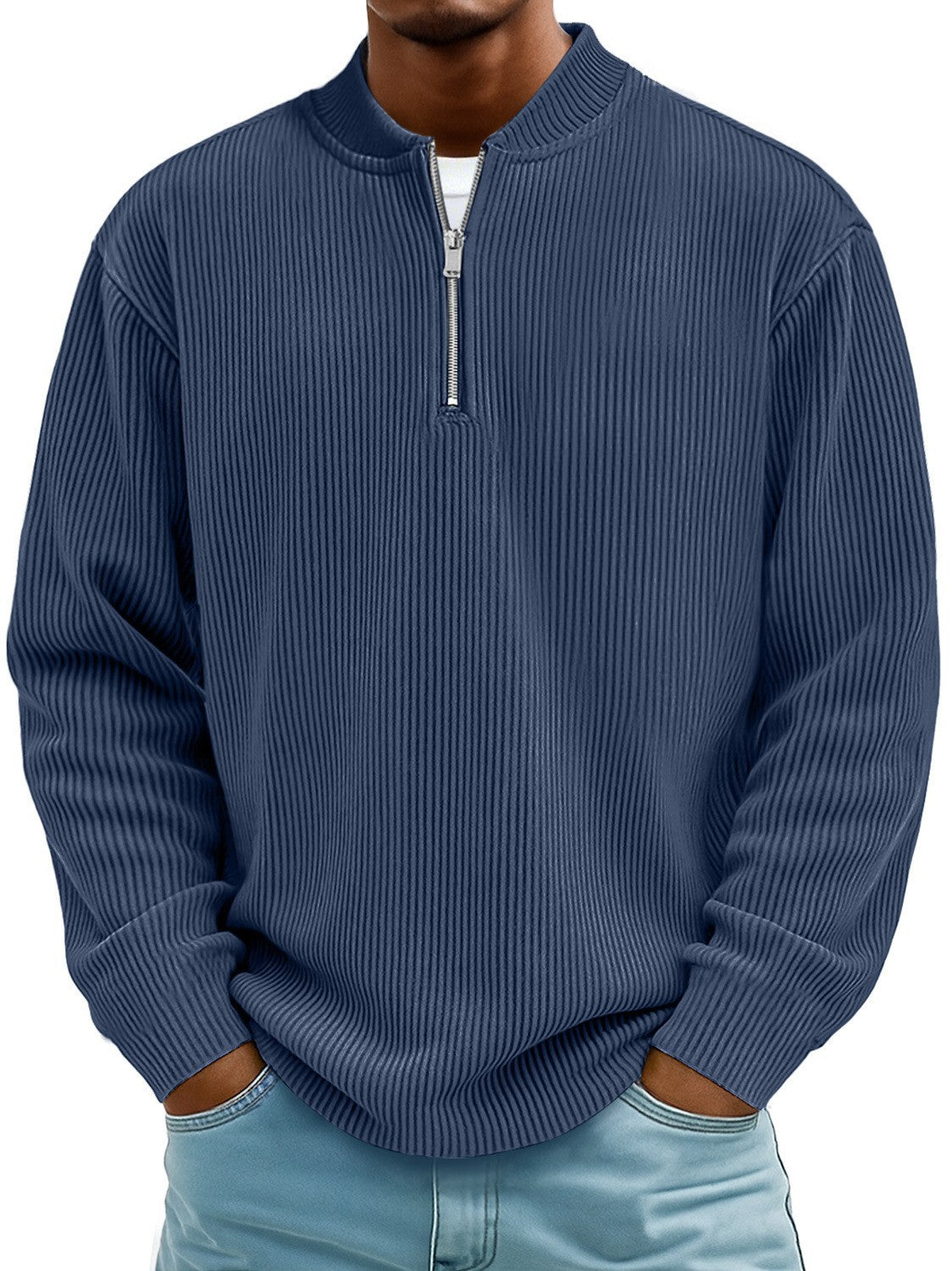 Man wearing a blue ribbed sweater with a zipper on a white background