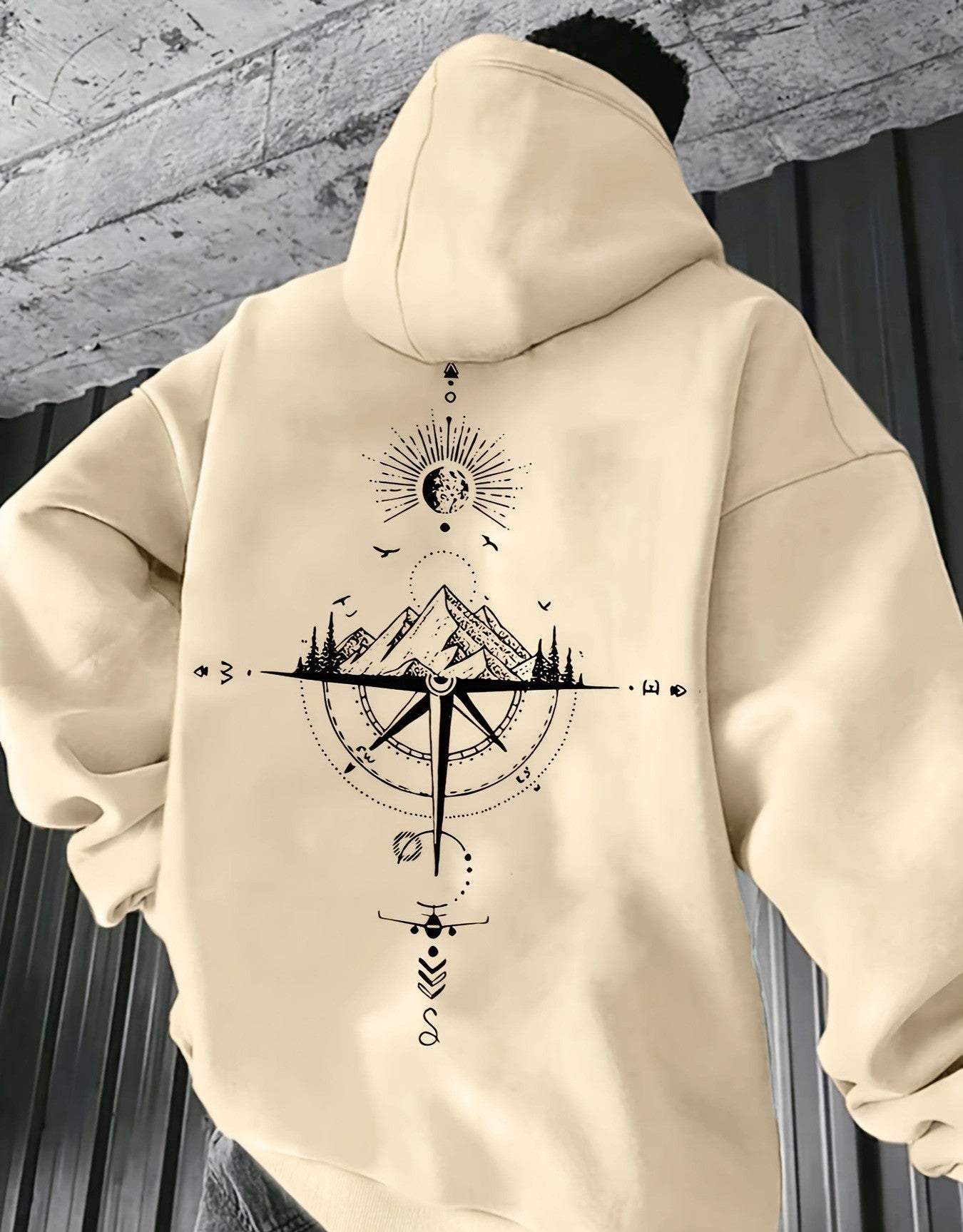 Beige hoodie with geometric design on a textured wall background