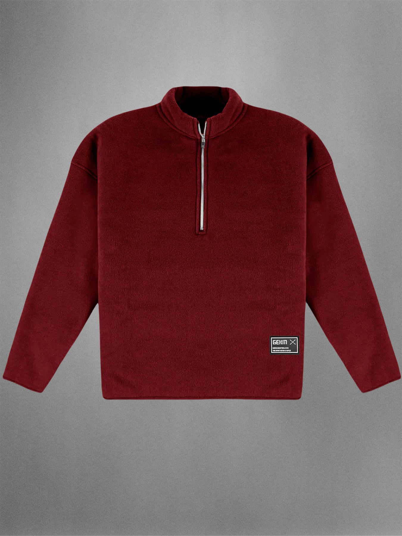 Red fleece pullover with a quarter zip on a gray background