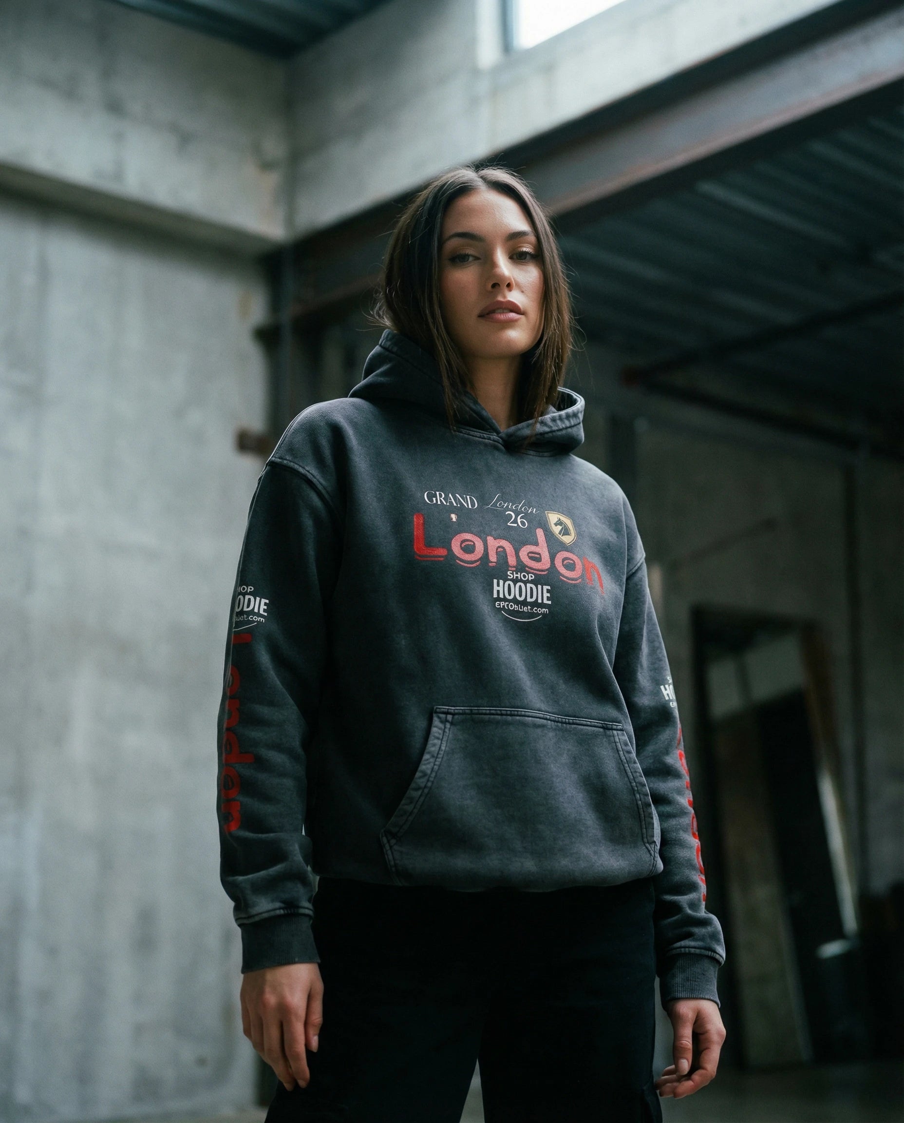 Person wearing a dark hoodie with text in an urban setting