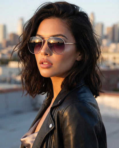 Woman wearing sunglasses and a leather jacket with a cityscape in the background