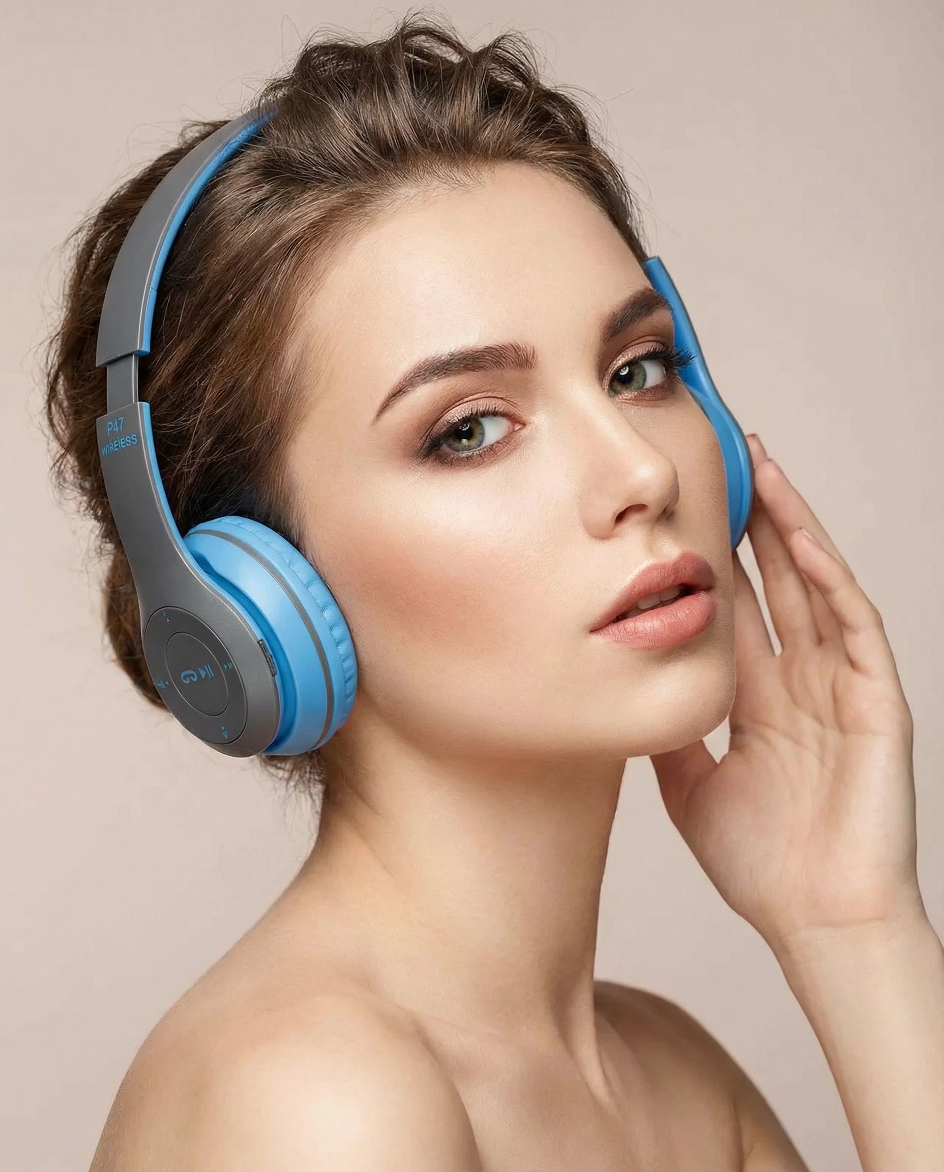 Woman wearing blue headphones with a neutral background