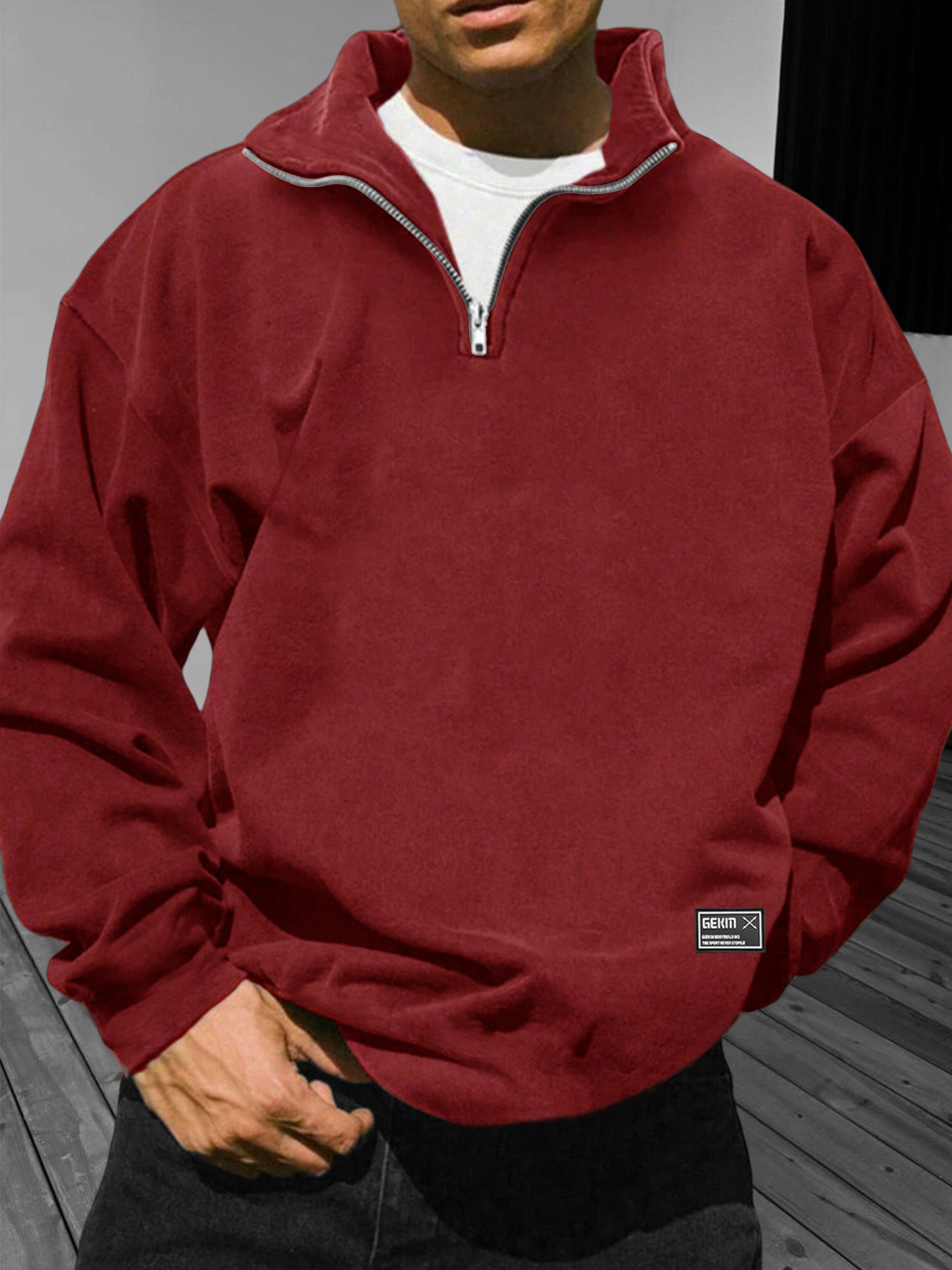 Person wearing a red fleece pullover with a visible brand logo on a neutral background