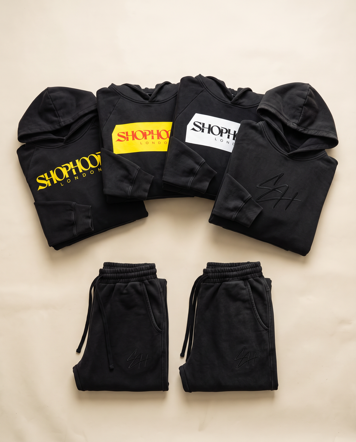SHOPHOODIE® LONDON flat lay — heavyweight streetwear collection on cream