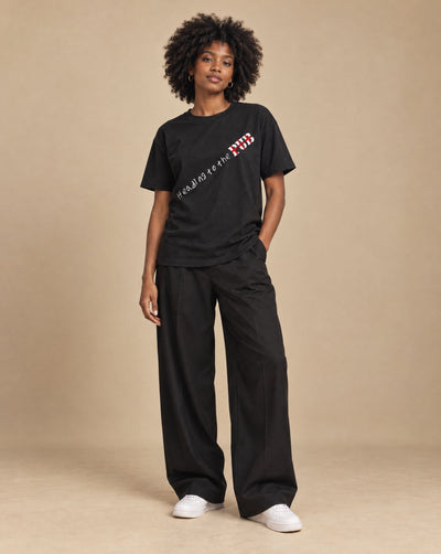 Female model wearing SHOPHOODIE HEADING TO THE PUB BRITISH ENGLAND Pure Cotton Unisex T-Shirt — 180 GSM, studio shot