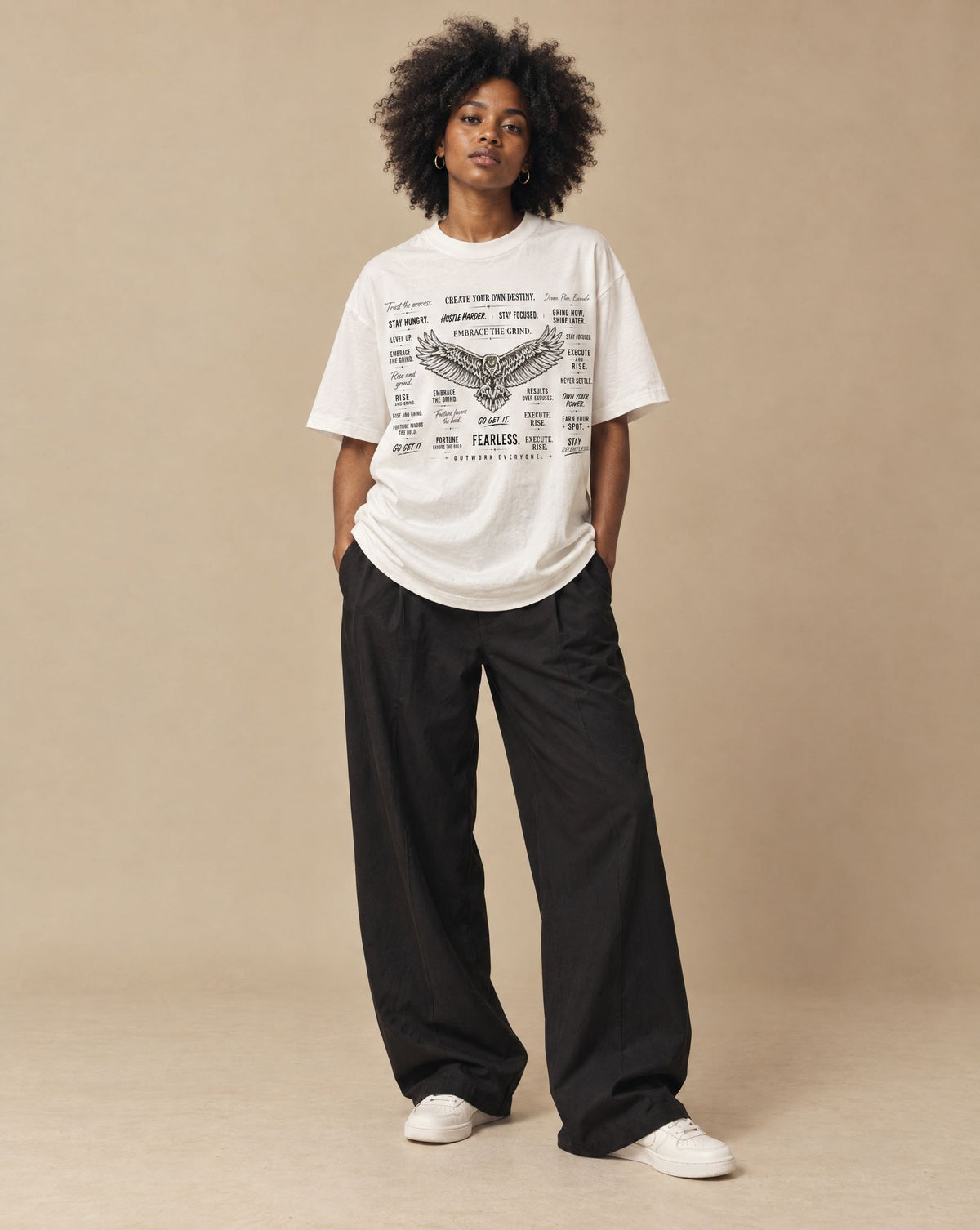 Female model wearing SHOPHOODIE EAGLE WINGS Unisex Oversized T-Shirt — 300 GSM, studio shot