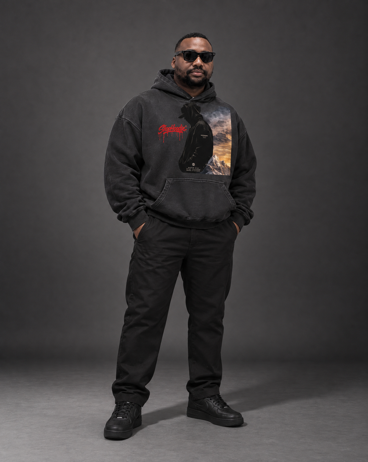 Model wearing the SHOPHOODIE EAGLE VISION Heavyweight Sunfade Oversized Hoodie in black, studio shot