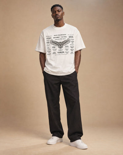 Male model wearing SHOPHOODIE EAGLE WINGS Unisex Oversized T-Shirt — 300 GSM, studio shot