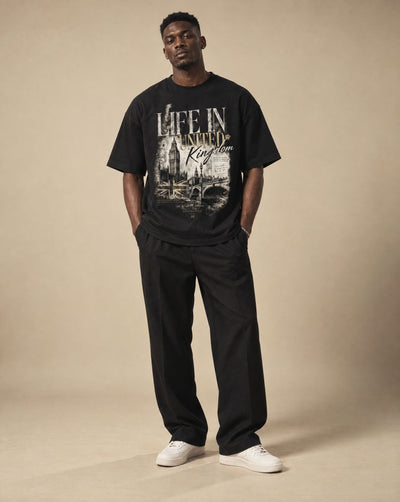 Male model wearing SHOPHOODIE LIFE IN UNITED KINGDOM Unisex Oversized T-Shirt — 300 GSM, studio shot