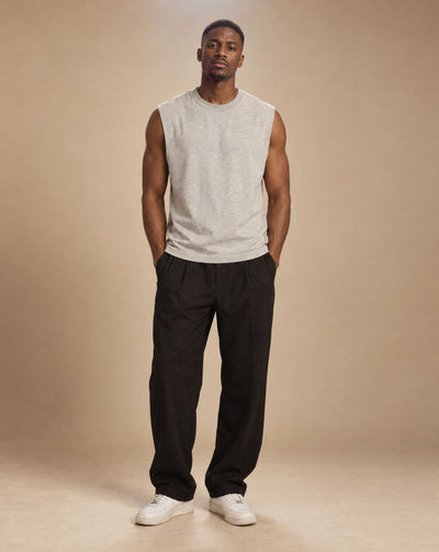 Male model wearing SHOPHOODIE BLANK Raw Edge Cotton Tank Top, studio shot
