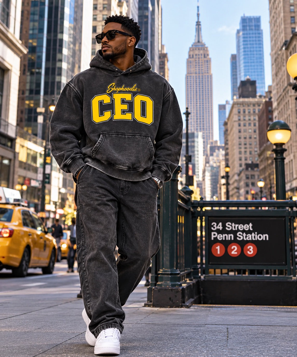 SHOPHOODIE CEO black and yellow hoodie worn by male model in Manhattan